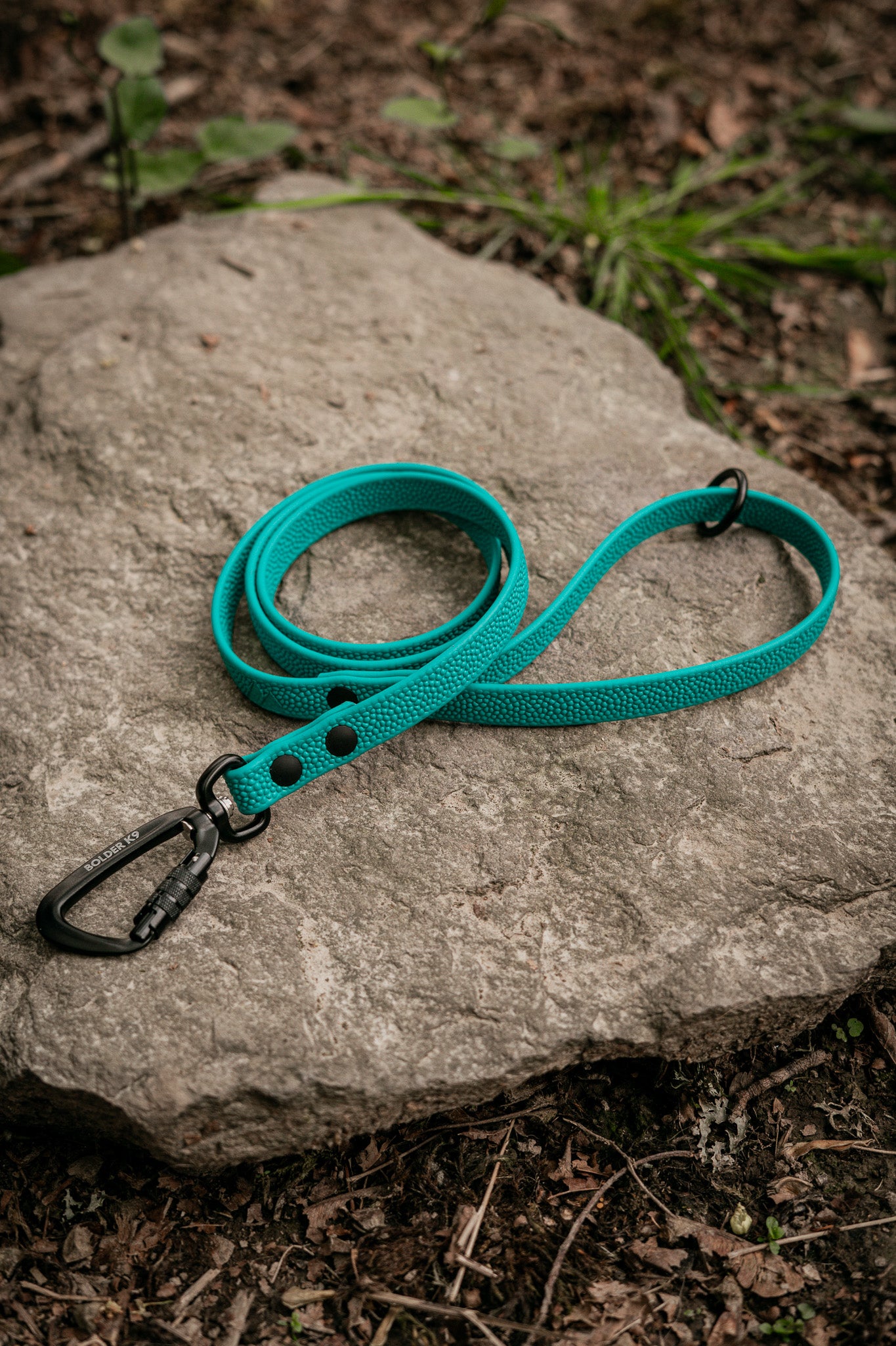 Pebble Grip BioThane® dog leash with a textured finish displayed on a rock outdoors.