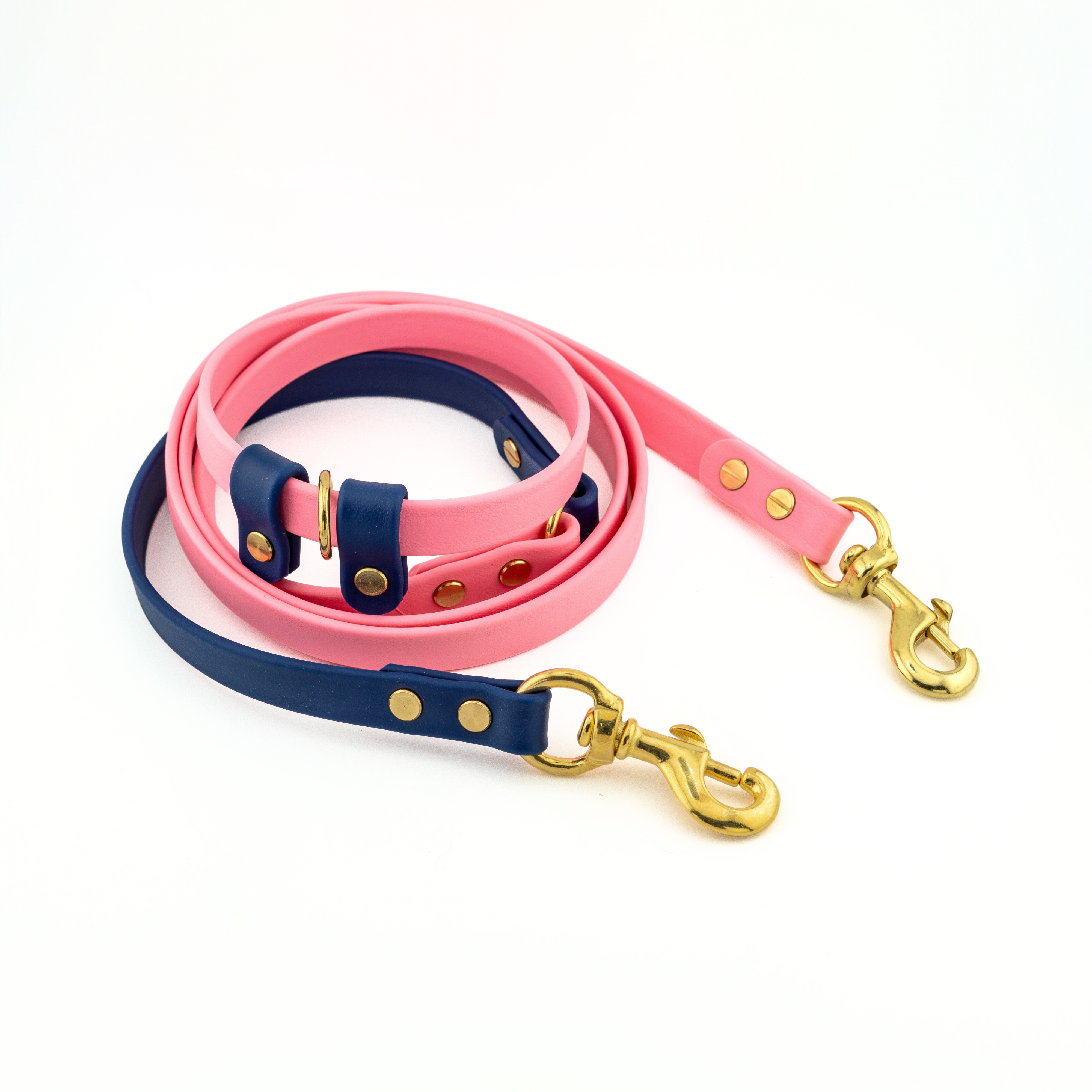 Voyager Adjustable BioThane Hands-Free Cross Body leash in pink and deep sea blue with solid brass hardware.