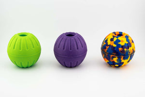 Three durable EVA foam balls with center holes in green, purple, and multicolored designs for pet play and fetch.