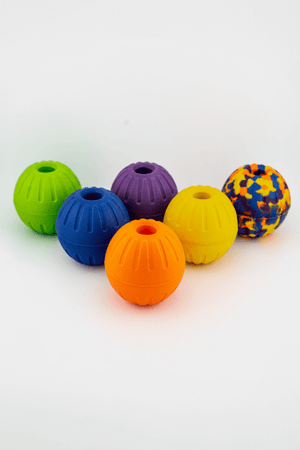 Colorful durable EVA foam balls with center holes for dog play and fetch.