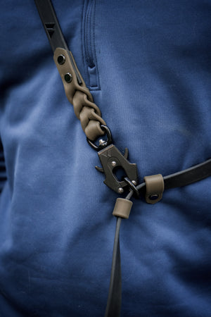 Trailblazer BioThane® cross-body leash with hand braided ends in action against a blue background.